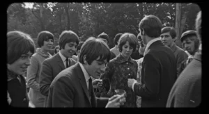 Embracing the Timeless Elegance: Exploring 60's Fashion Style for Women 10 a black and white photograph apturing a 1960s cultural event